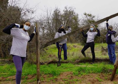 Volunteers posing while holding pieces of debris