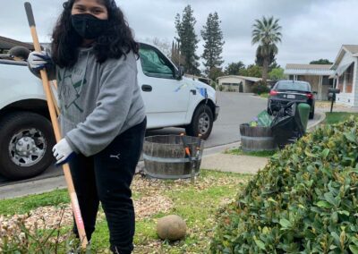 Volunteer raking debris