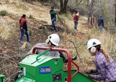 Volunteers at a wood chipper