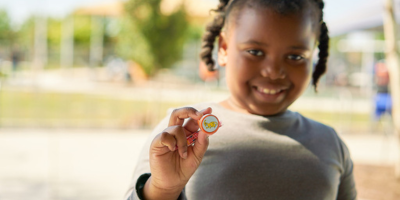 Little girl holding candy