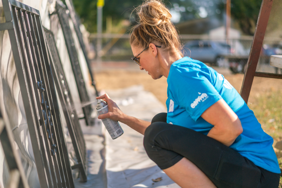 Image of woman painting metal frames