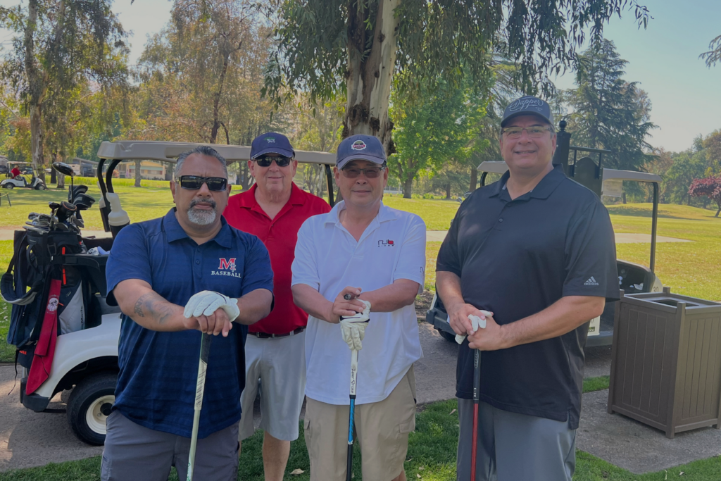 TFK Golfers 2 Four male golfers lined up for a picture.
